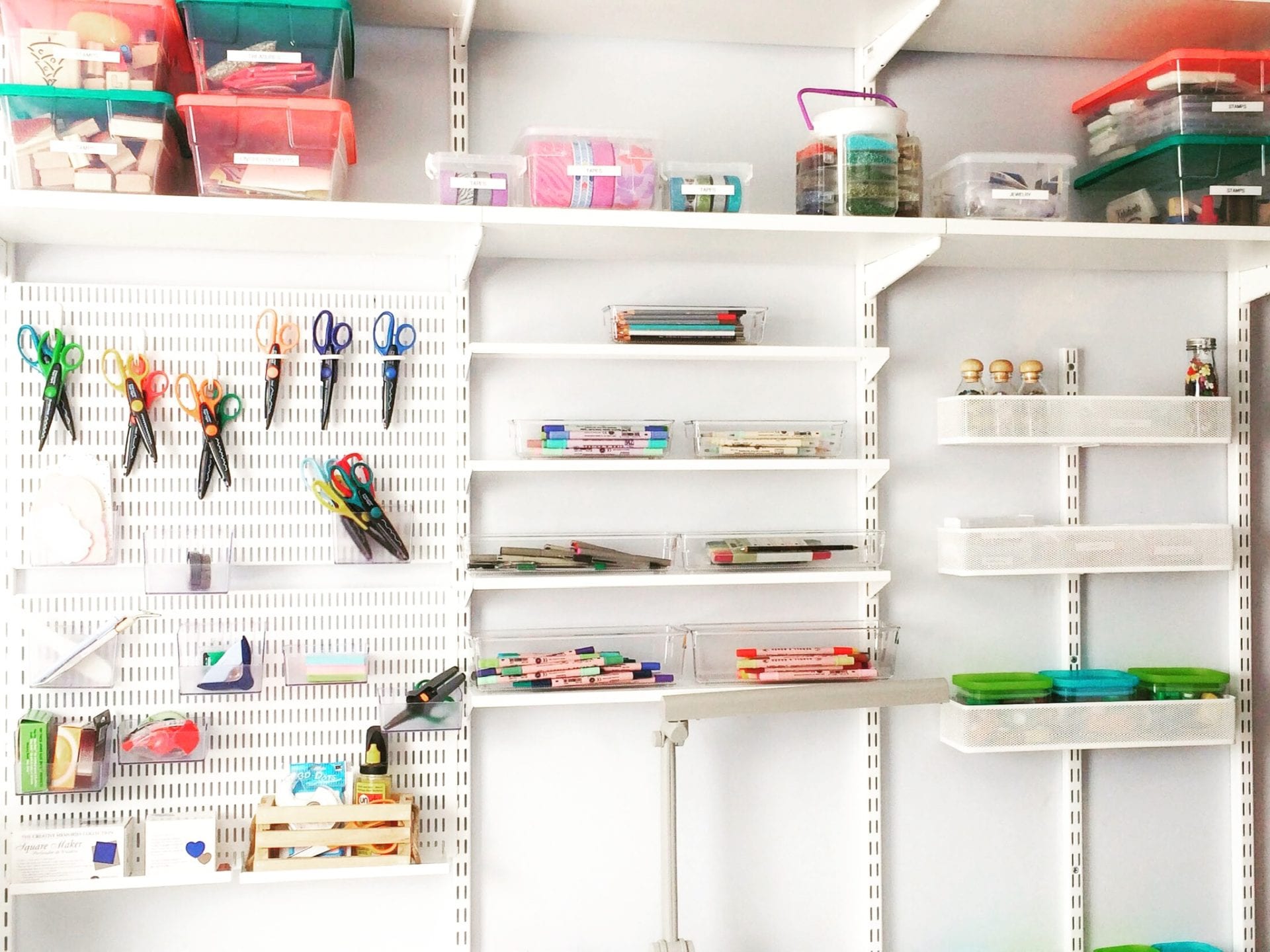 white clean organized craft room with organized shelving and labeled containers with professional organizer Stephanie Boyd help