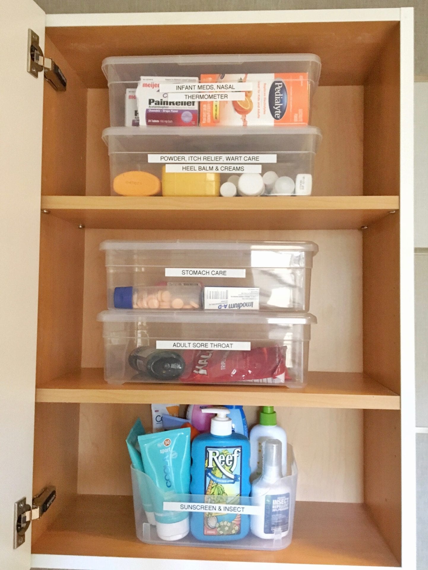 organized bathroom cabinet storage with labeled containers