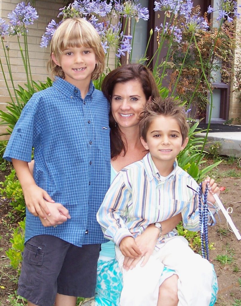 Steph outside with her sons, celebrating Carter's graduation from preschool