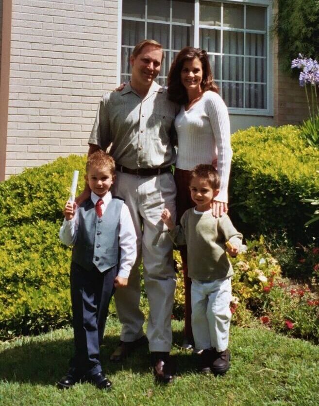 The family standing outside on a sunny day, celebrating Tyler's graduation from preschool